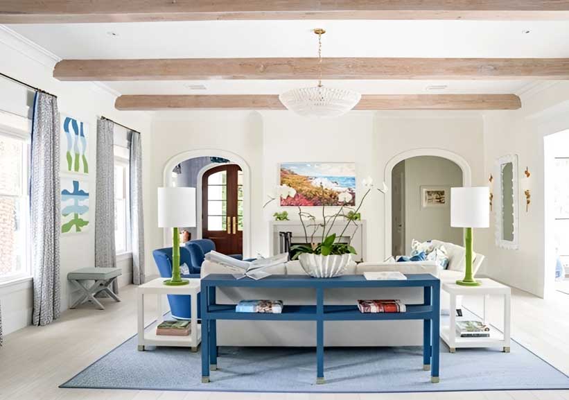 A living room with blue furniture and white walls.